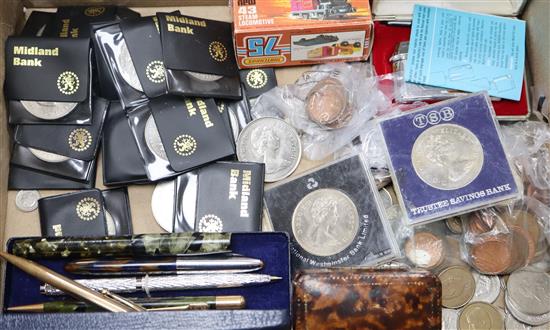 A quantity of mixed coins, pens, lighters, etc.